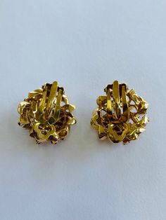 "This is a pair of 14K yellow gold and ruby clip-on earrings. Material(s): 14K yellow gold + several rubies per earring Total Weight: 17.8 grams Flaws (if any): None to mention Marking(s): \"14K\" Measurements: These earrings are 15/16 of an inch across. See photo with quarter for size comparison." Victorian Yellow Gold Clip-on Earrings, Victorian Style Yellow Gold Clip-on Earrings, Antique Clip-on Yellow Gold Earrings, Victorian Gold Clip-on Earrings For Anniversary, Victorian Style Gold Clip-on Earrings For Anniversary, Victorian Yellow Gold Clip-on Earrings For Formal Events, Gold Screw Back Clip-on Earrings For Anniversary, Formal Gold Screw Back Clip-on Earrings, Gold Screw Back Clip-on Earrings For Formal Occasions