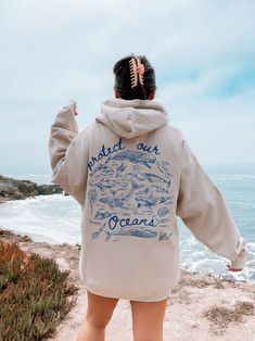 ✺  PROTECT OUR OCEANS - SALTED GRANOLA GIRL HOODIE ✺  * Q U I C K F A C T S * This design is a unique illustration that has been created in house. ✺ 50% Cotton 50% Polyester ✺ Medium-heavy fabric (8.0 oz/yd² (271.25 g/m ✺ Sizing is unisex so runs like men's, though not overly large ✺ Most women find their typical size works best, since they are meant to fit a touch loose Please note that COLOURS MAY APPEAR DIFFERENT on different digital screens and may not be a true representation of the actual Trendy Graphic Hoodies, Trendy Beach Hoodie With Letter Print, Salted Granola Girl, Cotton Hoodie With Graphic Print For Beach Season, Hooded Sweatshirt With Letter Print For Surfing, Shark Clothes, Protect Our Oceans Hoodie, Beach Hoodies, Ocean Sweatshirt