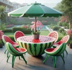 there is a table and chairs made out of watermelon with an umbrella over it