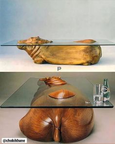 a glass and wood table with an animal head on it's top, and the bottom