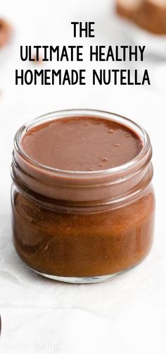 the ultimate healthy homemade nutella recipe in a glass jar with text overlay that reads, the ultimate healthy homemade nutella