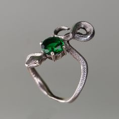 925 Silver Snake Emerald Ring,  925 Sterling Silver Ring, Emerald Snake Silver Ring, Emerald Snake Silver Ring, Animal Snake Jewelry Let's not forget that it is handmade. There may be minor differences. I can work the same ring with other natural Gemstones.  Please contact us to learn about our Gem stone stocks. If you have any questions, please feel free to contact me, we are happy to help. Your jewelry will be packed in a luxury jewelry box ready to be given as a special gift. Visit my shop to Symbolic Hand Forged Sterling Silver Rings, Green Snake Ring For Gift, Green Snake Ring Gift, Unique Hand Cast Snake Ring As Gift, Unique Hand Cast Snake Ring Gift, Silver Hand Forged Snake Ring Gift, Unique Sterling Silver Snake Ring As Gift, Unique Sterling Silver Emerald Ring, Hand Forged Silver Snake Ring Gift