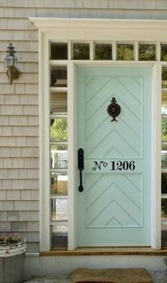 a blue front door on a house with the caption coastal charm