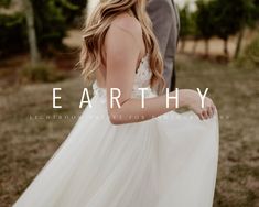 a man and woman standing next to each other in front of some trees with the words earthy on it