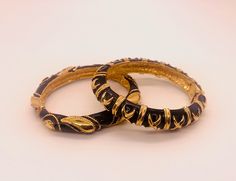 A stylish pair if Vintage 1980's hinged bracelets by designer Maresco. Each bracelet features a X motif repeated around the bracelet on a black enamel and gold tone bar. The bracelets are signed inside.  Outside dimensions: 2.75 inch L 2.5 inch W-  0.5 inch width of band  Inside dimensions : 6.12 inch ( length of the band ) Wedding Bracelets, Faux Pearl Earrings, Crystal Figurines, Wedding Jewelry Bracelets, Hinged Bracelet, Inside Outside, Green Crystals, Wedding Bracelet, White Enamel