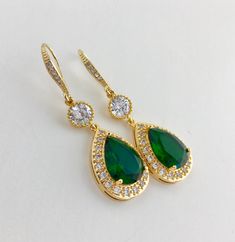 I've created these luxury green emerald cubic zirconia bridal teardrop earrings in gold plated brass setting. Earrings feature a large teardrop with pear cut green emerald cubic zirconia center surrounded by tiny round zirconia crystals. Teardrop dangles from a round cubic zirconia connector and zirconia detailed ear wire. Total length of the earrings is 5 cms For matching necklace click: https://www.etsy.com/listing/687185847/green-bridal-necklace-green-crystal?ref=related-1 For earrings and ne Green Gold-plated Earrings For Wedding, Green Gold-plated Bridal Earrings As Gift, Green Gold-plated Bridal Earrings For Wedding, Green Gold Plated Bridal Earrings For Wedding, Cubic Zirconia Teardrop Earrings For May Birthstone, May Birthstone Teardrop Cubic Zirconia Earrings, Green Drop Jewelry For Wedding, Gold Pear-shaped Cubic Zirconia Bridal Earrings, Elegant Teardrop Earrings For May Birthstone