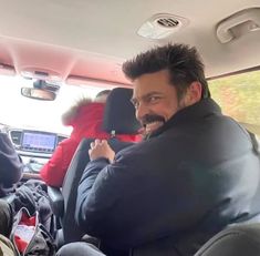 a man sitting in the back seat of a car