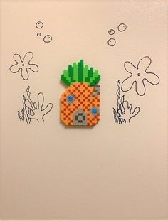 a piece of art made to look like a pixelated pineapple on the wall