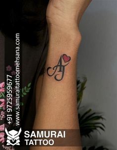 a woman with a tattoo on her arm holding up the letter a to symbolize love