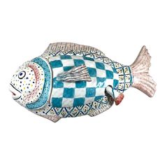 a ceramic fish with blue and white checkered design