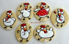 six decorated cookies in the shape of roosters