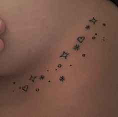 a woman's back with stars and hearts on her left side, while she has the word love written in black ink