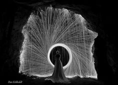 a woman standing in front of a light painting