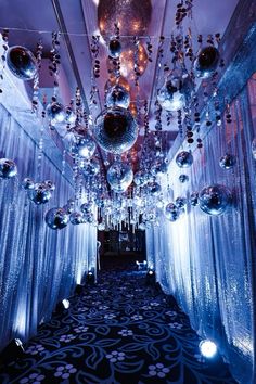 a hallway decorated with hanging ornaments and lights