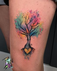 a colorful tree with heart shaped leaves on the side of her leg, painted in watercolors