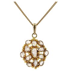 The Bethancourt Victorian rose cut diamond necklace is an authentic antique treasure from the romantic period. The cluster of these rustic, rose cut diamonds have distinctive "salt and pepper" internal characteristics that allow you to peer into their souls and are encircled with yellow gold bezels accented with beading. The pendant is smartly suspended by a free swinging bail and the original 20" chain. Condition: Very good Era: Victorian Year: 1885-1901 Metal: 18k Yellow Gold Diamonds: (13) Carat Weight: 0.72 carats total Color: L-N Clarity: SI2-I1 (Salt & Pepper) Cut: Rose Dimensions: Chain Length: 20" Pendant: 3/4" x 3/4" Weight: 5.9 grams Graded by GIA standards Includes: Certified Appraisal upon request, custom ring box, & free expedited shipping. 100% money back guarantee. Reasonabl Luxury Antique Necklaces With Rose Cut Diamonds, Luxury Pendant Necklaces With Rose Cut Diamonds, Rustic Rose, Custom Ring Box, Custom Ring, Cluster Pendant, Antique Roses, Modern Necklaces, Rose Cut Diamond