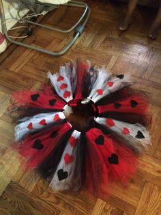 a red, white and black tutu skirt with hearts on the bottom is shown