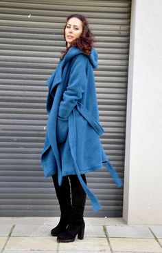 "Hooded Wool Coat, Winter Wool Coat, Dark Blue Coat Turquoise coat. Autumn-winter loose coat. Wool hooded maxi coat. Oversize wool jacket. Handmade item. The coat has a viscose lining. Two pockets, warm hood. Black 100% wool, best quality wool coat . Casual and warm, cozy and very comfortable . You can wear it in winter in warmer days, and in autumn and winter. Model wearing size : SIZE S Color : Turquoise SIZE S (US 6, UK 10, Italian 40, French 38, German 36, Japan 7) bust: fits bust around 35. Blue Winter Sweater Coat With Pockets, Oversized Long Blue Outerwear, Blue Oversized Hooded Outerwear, Winter Blue Parka With Drawstring Hood, Blue Winter Parka With Drawstring Hood, Blue Oversized Outerwear With Adjustable Hood, Casual Hooded Wool Coat With Pockets, Oversized Winter Coat, Dark Blue Coat