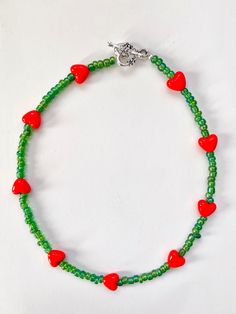 "The idea of \"Green Beaded with Red Heart Necklace\" came from the word \"Rose\".  It's simple but colorful. This necklace is good for daily wear, meeting friends, and parties. Material: glass beads, acrylic bead, Tibetan antique silver clasp Length: 15'' inches I hope you will like this necklace! Happy shopping :)" Heart-shaped Colorful Beads Jewelry For Gifts, Green Heart-shaped Beaded Necklace Gift, Handmade Green Jewelry For Valentine's Day, Valentine's Day Beaded Jewelry Gift, Heart And Round Beads Necklace For Gift, Handmade Red Heart Necklace For Valentine's Day, Colorful Beads Heart Shaped Beaded Necklace Gift, Heart Shaped Colorful Beaded Necklaces For Gifts, Red Heart Beads Jewelry For Crafting