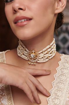 A work of art in jewelry, our Indian Bridal Kundan Choker Necklace captures the essence of celestial beauty and feminine grace. The centerpiece showcases a crescent moon motif, encrusted with Kundan, reflecting the radiance of the night sky strewn in luminous pearls. Every detail in this traditional pearl choker is inspired by the Sabyasachi Jewelry. From the delicate placement of pearls to the celestial motif,  the gold-plated necklace embodies a sense of celestial enchantment, inviting you to embrace the timeless beauty of the moon. Necklace- Adjustable Dori Weight- 57 gm Paisley Pop travels the depths of India to learn techniques and crafts from deep down in the local markets and villages. We give utmost importance to our quality and packaging. Our goal is to make sure you receive exact Choker Necklace Indian, Kundan Choker Necklace, Indian Choker Necklace, Necklace Traditional, Sabyasachi Jewellery, Kundan Choker, Necklace Indian, Kundan Necklace, Pearl Collection