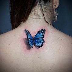 a woman with a blue butterfly tattoo on her back