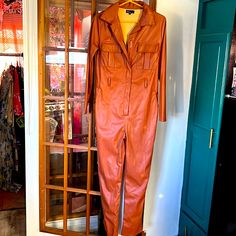 Cute Jumpsuit Or Coveralls. Never Worn. Has Pockets And A Zipper. Faux Leather. Brown Chic Overalls With Pockets For Fall, Brown Long Sleeve Jumpsuits For Night Out, Fitted Overalls With Pockets For Fall, Fitted Faux Leather Jumpsuits And Rompers For Fall, Trendy Brown Jumpsuits And Rompers For Work, Fitted Faux Leather Jumpsuits For Fall, Brown Jumpsuit For Fall Party, Leather Jumpsuits And Rompers For Fall, Fitted Jumpsuits And Rompers For Fall