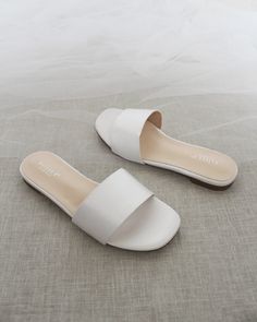 Classic slide flat sandals for casual and dressy look. Simple and easy wear for brides, bridesmaids and wedding parties.DETAILS:COLORS AVAILABLE: Ivory, Light Blue, White, Pink, and ChampagneUPPER: Synthetic upper and liningMATERIALS: Mandmade outsole STYLE NAME: EVELYN Cheap White Flat Slippers, White Slip On Sandals, White Flat Bridesmaid Wedding Shoes, Elegant White Slip-on Sandals, White Non-slip Flat Slippers, White Non-slip Flat Sandals, White Wedding Sandals, White Dress Sandals, White Sandals Flat