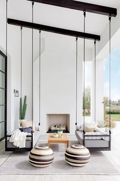 a living room filled with furniture and a fire place in the middle of a room