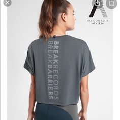 Athleta Nwt Legend Short Sleeve Short Tee “Break Record Barriers” Color: Bali Green Brand New With Tag $54.00 Size: 2x Oversized Fit, Super Soft On Body, Special Allyson Felix Graphic, Anti-Oder Technology, Moisture Wicking, Fair Trade Certified. Underarm To Underarm: 31", Back Of Neck To Hem: 23" 75% Polyester, 19% Lyocell, 7% Spandex, Super Soft!! Color: Bali Green Smoke And Pet Free Home Gray Short Sleeve Tops For Light Exercise, Gray Go-dry Tops For Light Sports, Gray Go-dry Sportswear Top, Gray Crew Neck Activewear For Light Exercise, Gray Go-dry Athleisure Top, Gray Relaxed Fit Top For Gym, Gray Relaxed Fit Workout Tops, Relaxed Fit Athleisure Tops For Gym, Go-dry Athletic Fit Tops For Sportswear