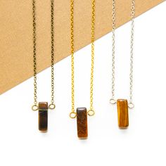 The Dainty Tiger's Eye Rectangle Necklace is perfect for those seeking spiritual grounding and clarity in their daily lives. Its unique blend of vintage and modern design makes it an ideal choice for fashion-forward individuals who appreciate a touch of retro flair. Each gemstone is natural and one-of-a-kind so please keep in mind, they may slightly vary in color, shape or size from the photos. All chain and components are hypoallergenic, making them ideal for individuals with sensitive skin. Ti Minimalist Necklace With Rectangular Stone For Gift, Minimalist Necklace With Rectangular Stone As Gift, Modern Necklace With Rectangular Stone For Gift, Minimalist Rectangular Stone Necklace For Gift, Minimalist Necklace With Rectangular Links Gift, Minimalist Rectangular Link Necklace As Gift, Everyday Spiritual Rectangular Pendant Jewelry, Handmade Brown Rectangular Necklaces, Everyday Spiritual Brown Necklace