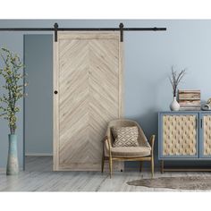 a room with blue walls, a chair and a wooden door that has an arrow pattern on it