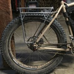 a bicycle parked next to a pile of logs