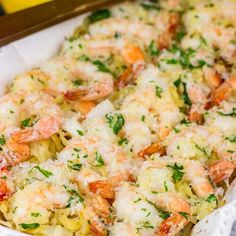 shrimp and pasta casserole with parmesan cheese in a white dish on a table