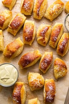 baked pastries on a cutting board with dipping sauce