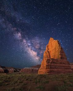 the night sky is filled with stars and bright lights, as well as some rocks