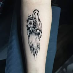 a black and white image of a ghost with flowers on it's arm,