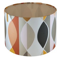 a lampshade with an abstract design on the bottom and tan lining around it