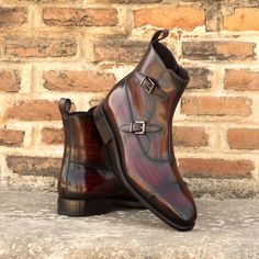 "Materials: burgundy patina Lining: brown calf leather Sole: dark red Goodyear Welt leather sole with mountain rubber injections Last: Sleek looking aesthetic with slight chisel toe The Octavian blends the elevated style of a distinguished monk dress shoe with the durable and relaxed vibe of a boot. Featuring a double buckle monk and side zip fastening, these smart boots will allow you to move from the boardroom to the bar effortlessly. Artisan-Hand Made Patina: The technique used to achieve thi Plus Size Boots, Men High Heels, Artistic Shoes, Buckle Boot, Wedding Boots, Gentleman Shoes, Breaking In, Elevated Style, Dress Boots