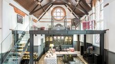 a living room filled with furniture and a spiral staircase