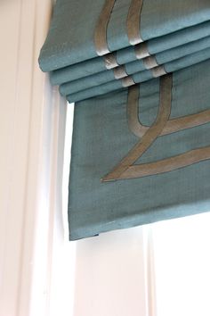 a stack of folded towels sitting on top of a window sill