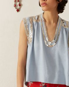 Rendered in silk with a slubbed finish, our sky blue sleeveless top is hand-embellished with silver paillettes stitched along the neckline and armholes. The vintage-inspired Bohemian top can easily go from day to evening, no additional jewelry needed. This one-of-a-kind textile was embroidered by hand. Subtle variations are part of the unique beauty of the garment and a signature of the artisan's hand. Bohemian Top, Western Tops, Bohemian Tops, Vacation Dresses, Spring Tops, New Arrival Dress, Indian Wear, Guest Dresses, Summer Collection