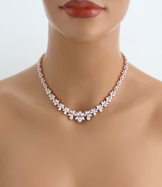 Amazing Rose gold back necklace created with sparkly Cubic zirconia stones that sparkle like diamonds ! Perfect for any bride or special occasion. Created with Swarovski Pure Brilliance stones. Available in rose gold, yellow gold or rhodium (silver) finishes. Necklace measures 16 inches and extends to 18 inches Backdrop measures 7 inches Matching bracelet: https://www.etsy.com/listing/594245340/rose-gold-bracelet-bridal-bracelet?ref=shop_home_active_1 Matching earrings: https://www.etsy.com/list Rose Gold Wedding Necklace With Diamond Accents, Rose Gold Diamond Accent Wedding Necklace, Rose Gold Wedding Necklaces With Diamond Accents, Wedding Rose Gold Necklace With Diamond Accents, Dazzling Rose Gold Diamond Necklace For Weddings, Rose Gold Bridal Necklace With Diamond Accents For Anniversary, Sparkling Rose Gold Cubic Zirconia Necklace, Rose Gold Cubic Zirconia Bridal Necklace For Anniversary, Dazzling Rose Gold Necklace With Cubic Zirconia