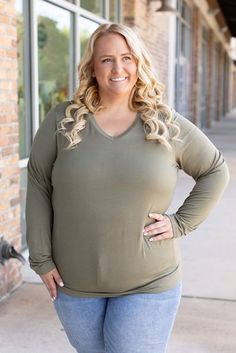 Add sophistication to your everyday attire with the Larissa Long Sleeve Top in olive. This essential V-neck top blends timeless style with modern comfort, making it perfect for any occasion. Crafted from a soft mix of 95% rayon and 5% spandex, it offers a snug yet flexible fit that moves with you. Whether you're dressing up for a night out or keeping it casual for a day in, this top ensures you stay cozy with its long sleeves and relaxed fit. Fabric Composition: Premium blend of 95% rayon and 5% spandex for supreme comfort.Fit: Designed to run true to size for a perfect fit every time.Model Sizing: Tiffanee is effortlessly stylish in a size small, while Lexi looks stunning in 1XL. Versatile Green V-neck Top, Olive V-neck Tops For Spring, Casual Olive V-neck Top, Stay Cozy, Beautiful Eyes, V Neck Tops, Top Trends, Timeless Style, Long Sleeve Top