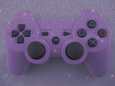 an overhead view of a purple video game controller with sparkles in the back ground