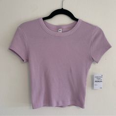 Women’s Light Purple Ribbed Cropped Baby Tee Size Small New With Tags Also Available In Dark Blue/Purple Color Purple Ribbed Stretch Top, Purple Stretch Ribbed Tops, Stretch Purple Ribbed Tops, Stretch Ribbed Purple Tops, Casual Purple Ribbed Top, Casual Purple Crew Neck Crop Top, Purple Ribbed Top, Fitted Basic Purple Top, Purple Ribbed Tops For Summer