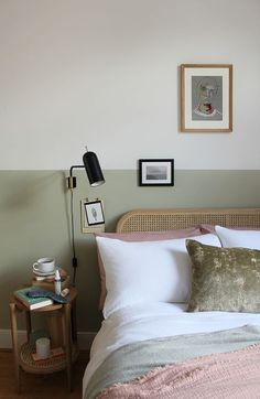 a bedroom with a bed, nightstand and pictures on the wall