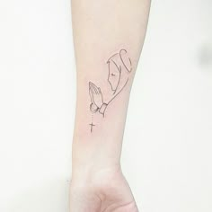 a woman's arm with a small tattoo on it