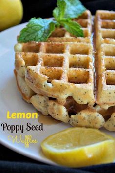 lemon poppy seed waffles on a white plate with a slice of lemon next to it