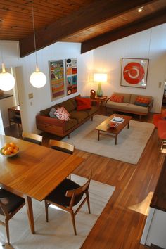 a living room filled with furniture and a wooden table