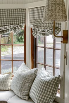 a window seat with several pillows on it